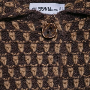 Women's knit cardigan featuring a brown jacquard pattern and vintage button detail