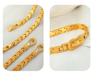 Detailed close-up showing the golden belt buckle clasp and industrial link chain texture