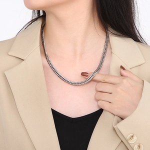 Polished silver cuban chain necklace worn with a stylish suit for a modern look
