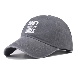 Washed dark gray cotton baseball cap with white Don't Forget To Smile text print