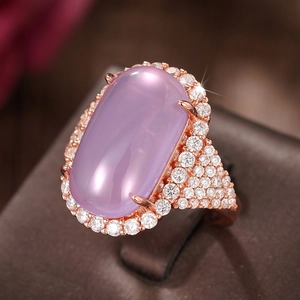 Macro view of oval lavender gemstone ring with pave diamonds on rose gold band