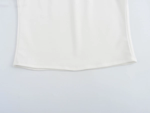 Detail shot of the clean double-needle stitched hem on this white beaded camisole top