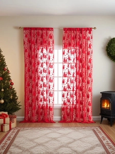 Detail of red sheer Christmas curtains with Happy Holidays reindeer and tree prints