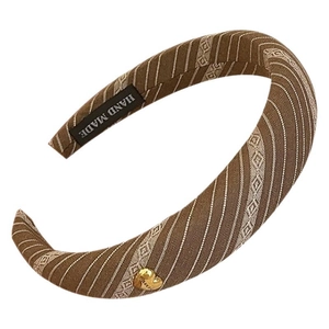 Brown padded sponge headband with beige stripes and a small gold heart charm