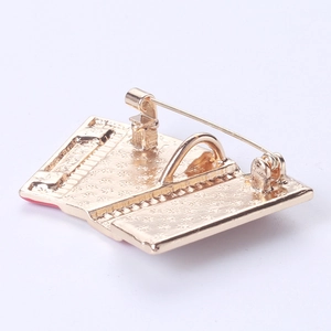Macro view of the golden metal brooch back with secure safety pin and locking clasp