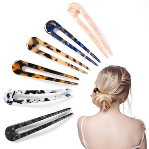 U-shaped acetate hair pins in multiple marble patterns shown on a female model