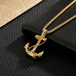 Close-up of golden stainless steel anchor pendant with rope detail on box chain