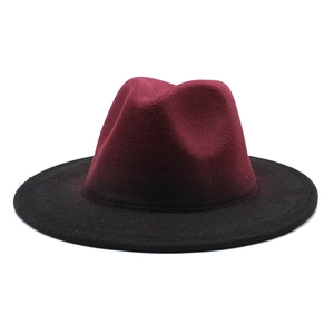 Detail of a two-tone gradient felt fedora hat featuring a wine red crown and black brim