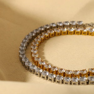 Elegant gold and silver tennis bracelets with cubic zirconia in a classic four-claw setting