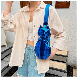 Detail of blue cat-shaped crossbody bag with glossy metallic finish and nylon strap