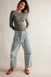 Detail of blue and white striped wide-leg pants with thick drawstring and metal eyelets