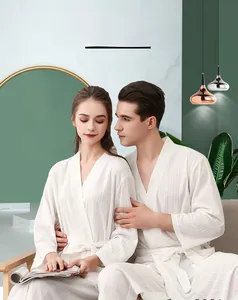 Detailed view of white waffle texture fabric on a minimalist V-neck bathrobe