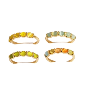 Set of four gold-plated minimalist rings with colorful cat eye stones in various shades
