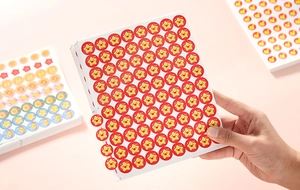 Close-up of red and yellow star reward stickers for students and kids on white background