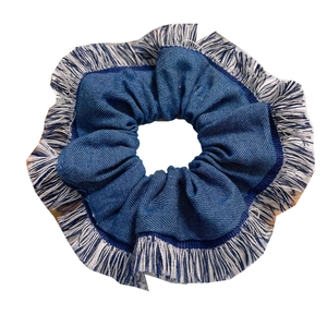 Blue denim hair scrunchie with white fringe edges shown on a clean white background