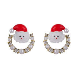 Detail of Santa Claus earrings with gold hoops, pearls and rhinestones on white background