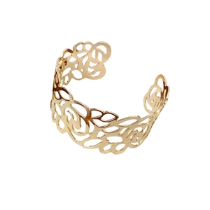 Exaggerated gold metal open cuff bracelet with intricate floral cutout patterns
