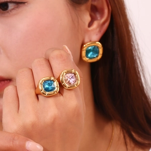 Detail view of retro 18K gold plated rings and earrings with colorful zircon stones