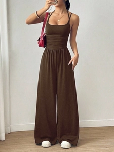 Close-up of a dark brown halter neck wide-leg jumpsuit with a waist-cinching fit