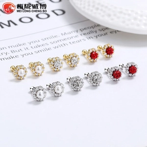 Detailed macro view of S925 silver screw back stud earrings with micro paved crystals and pearls