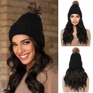 Detail of 12-inch long wavy hair wig with black knit beanie and brown pompom top