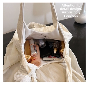 Interior view of white quilted tote bag showing large capacity and internal zipper pocket
