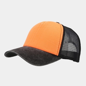 Detail of washed trucker hat showing orange front panel and breathable black mesh back