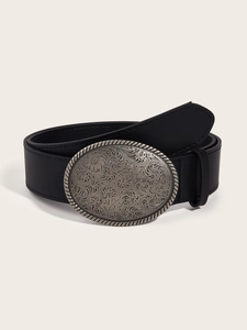Detail of western retro belt buckle with flower carvings and black leather strap
