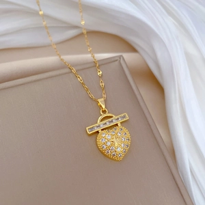 Luxurious gold heart pendant necklace with shimmering crystals on elegant silk background