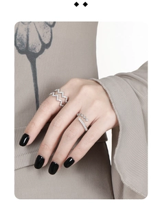 Detailed view of silver S925 rings with geometric diamonds and wave pattern on model