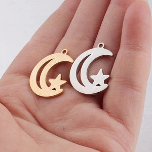 Close-up of gold and silver moon and star stainless steel charms for DIY jewelry