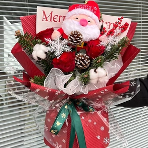 Christmas bouquet with Santa plush toy red roses pine cones and festive wrap decor