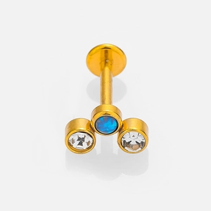 Detailed macro view of 16G gold plated stainless steel labret stud with blue zircon gems