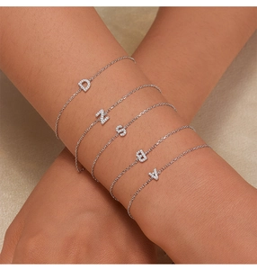 Detail of 925 sterling silver alphabet bracelets with sparkling micro-paved cubic zirconia