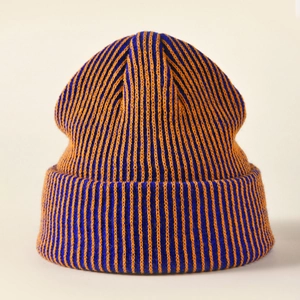 Detailed view of the thick orange and blue striped knit texture on the beanie fold