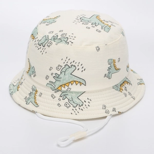 Détail chapeau soleil enfant crème avec imprimés dinosaures et cordon réglable blanc