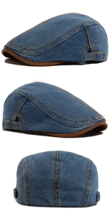 Close-up of contrast stitching and adjustable metal buckle on vintage denim flat cap