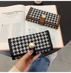 Detail of houndstooth fabric long wallets with premium leather trim and gold snap button