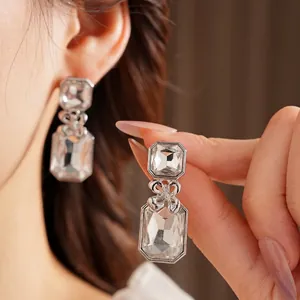 Silver drop earrings with square and rectangular crystals and a delicate metal bow knot