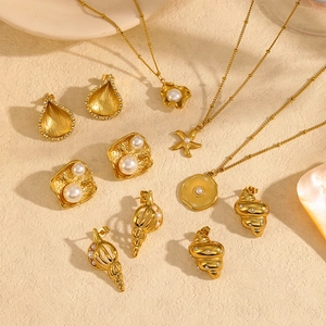 Golden starfish and shell necklace set with pearls and diamonds on a beige textured surface