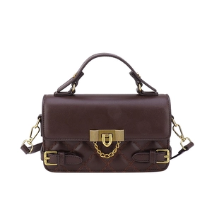 Classic dark brown quilted leather handbag with gold metal clasp on a clean white background