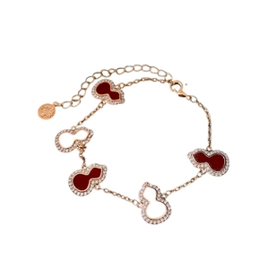 Golden bracelet featuring red enamel and hollow Wu Lou pendants with white zircon accents