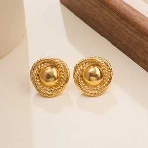 Detailed macro view of 18k gold plated round earrings with vintage woven texture edges