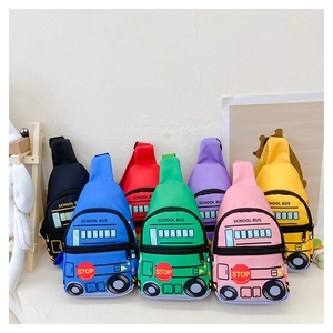 Multiple colors of school bus shaped crossbody bags for kids displayed in a row