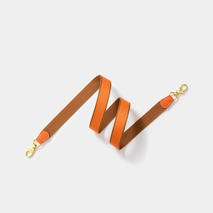 Adjustable canvas webbing shoulder strap in orange and brown with golden metal swivel hooks