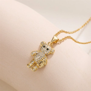 Detailed macro of golden bear pendant with sparkling zirconia and small flower detail
