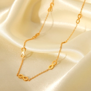 18K gold plated stainless steel infinity link necklace on elegant beige silk background