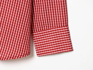 Detailed close-up of red and white gingham poplin shirt cuffs with precision stitching