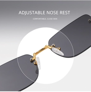 Close-up of adjustable nose pads and golden metal bridge on rimless sunglasses