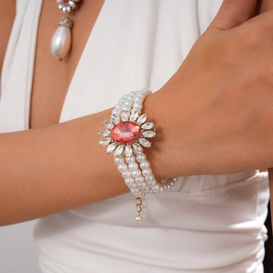 Detail of baroque multilayer pearl necklace with red crystal centerpiece and teardrop charm